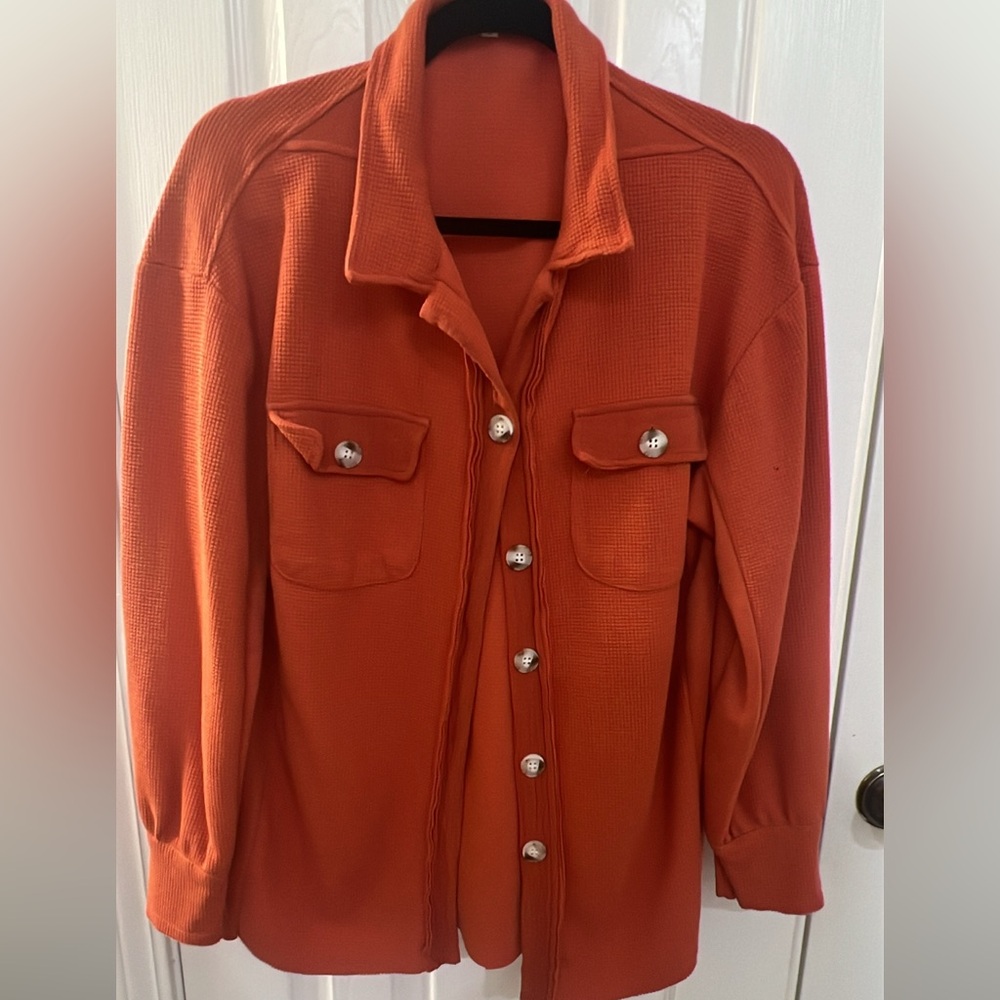 Burnt orange. From a local boutique; never worn. Size small.